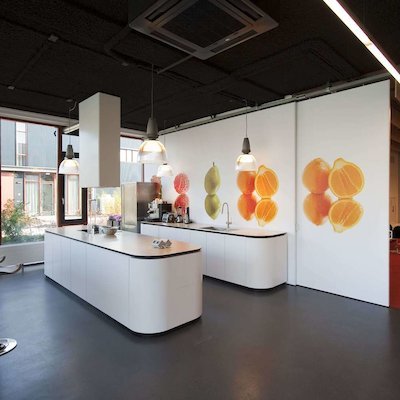 Liong Lie architects Grand Catering kitchen and reception area divided by a sliding wall with fruit print
